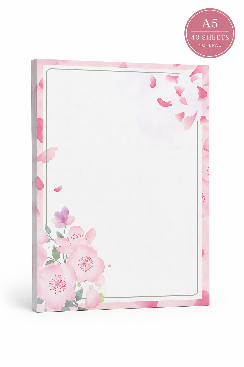 A vertical notepad or letterhead pad with a pink floral border design, displayed on a small wooden stand on a tabletop. The scene includes a glass vase with blossoms, a pen on a pink marble notebook, a key, eyeglasses, and an open jewelry box in a softly lit indoor setting.